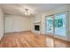 Living room with hardwood floors, white brick fireplace, and sliding door at 751 Oneta Dr, Norcross, GA 30093