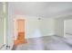 Bright living room featuring neutral paint, plush carpet and adjacent access to other rooms at 751 Oneta Dr, Norcross, GA 30093