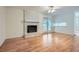 Living room with hardwood floors and white brick fireplace at 751 Oneta Dr, Norcross, GA 30093
