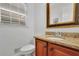 Well-lit bathroom with a granite countertop vanity and a modern toilet at 1569 Chateau Dr, Dunwoody, GA 30338