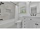 Bright bathroom featuring marble-look shower tiles, modern fixtures and a hexagon tiled floor at 1569 Chateau Dr, Dunwoody, GA 30338