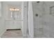 Bathroom showcasing marble-look shower tiling and modern fixtures with white vanity at 1569 Chateau Dr, Dunwoody, GA 30338
