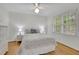 Cozy bedroom with hardwood floors, a ceiling fan, and a dresser with a wicker design at 1569 Chateau Dr, Dunwoody, GA 30338