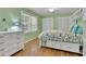 Bright bedroom with hardwood floors, a ceiling fan, and built-in storage and shelves around the bed at 1569 Chateau Dr, Dunwoody, GA 30338
