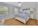 Well-lit bedroom with hardwood floors and built-in cabinets and shelves surrounding the headboard at 1569 Chateau Dr, Dunwoody, GA 30338