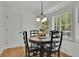 Bright breakfast nook with a round table, black chairs, and a window with shutter blinds at 1569 Chateau Dr, Dunwoody, GA 30338