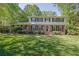 Charming two-story home with a brick facade, black shutters, and a well-manicured front lawn at 1569 Chateau Dr, Dunwoody, GA 30338