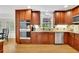 Spacious kitchen with wooden cabinets, granite countertops, stainless steel appliances, and hardwood floors at 1569 Chateau Dr, Dunwoody, GA 30338