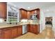 Well-equipped kitchen with wooden cabinets, granite countertops, stainless steel appliances, and hardwood floors at 1569 Chateau Dr, Dunwoody, GA 30338