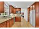 Modern kitchen with wooden cabinets, stainless steel appliances, hardwood floors, and an open layout at 1569 Chateau Dr, Dunwoody, GA 30338