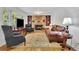 Cozy living room with a brick fireplace, built-in bookshelves, and comfortable seating area at 1569 Chateau Dr, Dunwoody, GA 30338
