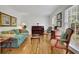 Bright living room with hardwood floors, piano, and large windows offering great natural light at 1569 Chateau Dr, Dunwoody, GA 30338