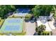 Overview of well-maintained tennis courts and clubhouse, ideal for sports enthusiasts and social gatherings at 1569 Chateau Dr, Dunwoody, GA 30338