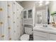 Bathroom with white vanity, commode, and polka dot shower curtain at 1711 Taynton Cir, Kennesaw, GA 30152
