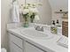 Bathroom featuring white vanity, decorative mirror and stylish accessories at 1711 Taynton Cir, Kennesaw, GA 30152