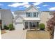 Inviting two-story home with charming curb appeal, a bench on the porch, a well-manicured lawn, and a driveway at 1711 Taynton Cir, Kennesaw, GA 30152