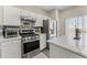 Well-equipped kitchen with white cabinets, stainless steel appliances, modern finishes and great countertops at 1711 Taynton Cir, Kennesaw, GA 30152
