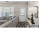Cozy living room with a large window, sectional couch, white trim, and a stylish console table at 1711 Taynton Cir, Kennesaw, GA 30152