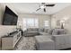 Inviting living room with a sectional couch, large window, stylish rug, a large television, and modern decor at 1711 Taynton Cir, Kennesaw, GA 30152