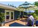 Outdoor deck area with umbrellas, tables and chairs create an inviting outdoor gathering space at 2673 Rainbow Forest Dr, Decatur, GA 30034