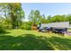 Aerial view of the home and deck overlooks a spacious backyard with mature trees and lush lawn at 2673 Rainbow Forest Dr, Decatur, GA 30034