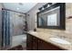 Bathroom featuring granite countertops, a large mirror, a shower and bathtub combo, and tile flooring at 2673 Rainbow Forest Dr, Decatur, GA 30034