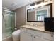 Bathroom featuring granite countertops, a large mirror, walk-in shower, and tile flooring at 2673 Rainbow Forest Dr, Decatur, GA 30034