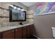 Bathroom featuring a double sink vanity with granite countertops and decorative backsplash at 2673 Rainbow Forest Dr, Decatur, GA 30034