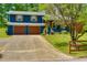 Charming blue two-story home with a two-car garage, wooden shutters, and well-maintained landscaping at 2673 Rainbow Forest Dr, Decatur, GA 30034