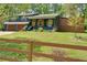 Charming blue two-story home with a two-car garage, wooden shutters, landscaping, and a privacy fence at 2673 Rainbow Forest Dr, Decatur, GA 30034