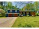Charming blue two-story home with a two-car garage, wooden shutters, and well-maintained landscaping at 2673 Rainbow Forest Dr, Decatur, GA 30034