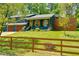 Charming blue two-story home with a two-car garage, wooden shutters, landscaping, and a privacy fence at 2673 Rainbow Forest Dr, Decatur, GA 30034