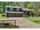 Charming blue two-story home with a two-car garage, wooden shutters, and well-maintained landscaping at 2673 Rainbow Forest Dr, Decatur, GA 30034