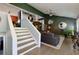 Open living room with hardwood floors, a ceiling fan, and a staircase leading to upper level at 2673 Rainbow Forest Dr, Decatur, GA 30034