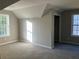 Carpeted bedroom features vaulted ceilings, a window, and a doorway at 4018 Dorchester Nw Walk, Kennesaw, GA 30144