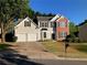 Charming two-story home with a manicured front yard and a two-car garage at 4018 Dorchester Nw Walk, Kennesaw, GA 30144