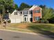 Two-story home with a brick accent and a two-car garage on a sunny day at 4018 Dorchester Nw Walk, Kennesaw, GA 30144