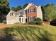 Attractive two-story home with gray siding, a brick accent, and a manicured lawn at 4018 Dorchester Nw Walk, Kennesaw, GA 30144