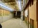 View of the unfinished basement with exposed pipes and wooden framing for future build-out at 25 Derby Dr, Hiram, GA 30141