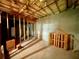 Unfinished basement featuring a concrete floor, exposed ceiling, and wooden framing at 25 Derby Dr, Hiram, GA 30141