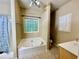 Bathroom with separate shower and tub, vanity, and a textured glass window to give great light at 25 Derby Dr, Hiram, GA 30141