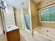 Bright bathroom with a large tub and a stylish window providing natural light and a touch of elegance at 25 Derby Dr, Hiram, GA 30141
