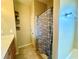 Functional bathroom features tub with shower, vanity, and practical storage shelves for all your needs at 25 Derby Dr, Hiram, GA 30141
