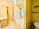 Bathroom featuring a soaking tub, tiled floors, and a vanity sink in a well-lit space at 25 Derby Dr, Hiram, GA 30141