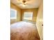 Bright bedroom with two windows, ceiling fan, carpeted floor and neutral colored walls at 25 Derby Dr, Hiram, GA 30141