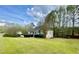 Lovely home with lush green lawn and wooded backdrop, blending comfort and nature at 25 Derby Dr, Hiram, GA 30141