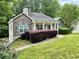 Single story home featuring a stone facade, covered porch, lush front lawn, and manicured landscaping at 25 Derby Dr, Hiram, GA 30141