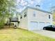 Two-story home with vinyl siding, a small deck, three-car garage, and well-maintained lawn at 25 Derby Dr, Hiram, GA 30141