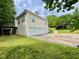 Two-story home with vinyl siding, a small deck, and a three-car garage with long driveway at 25 Derby Dr, Hiram, GA 30141