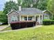 Charming single-story home featuring a stone facade, manicured lawn, and inviting front porch at 25 Derby Dr, Hiram, GA 30141